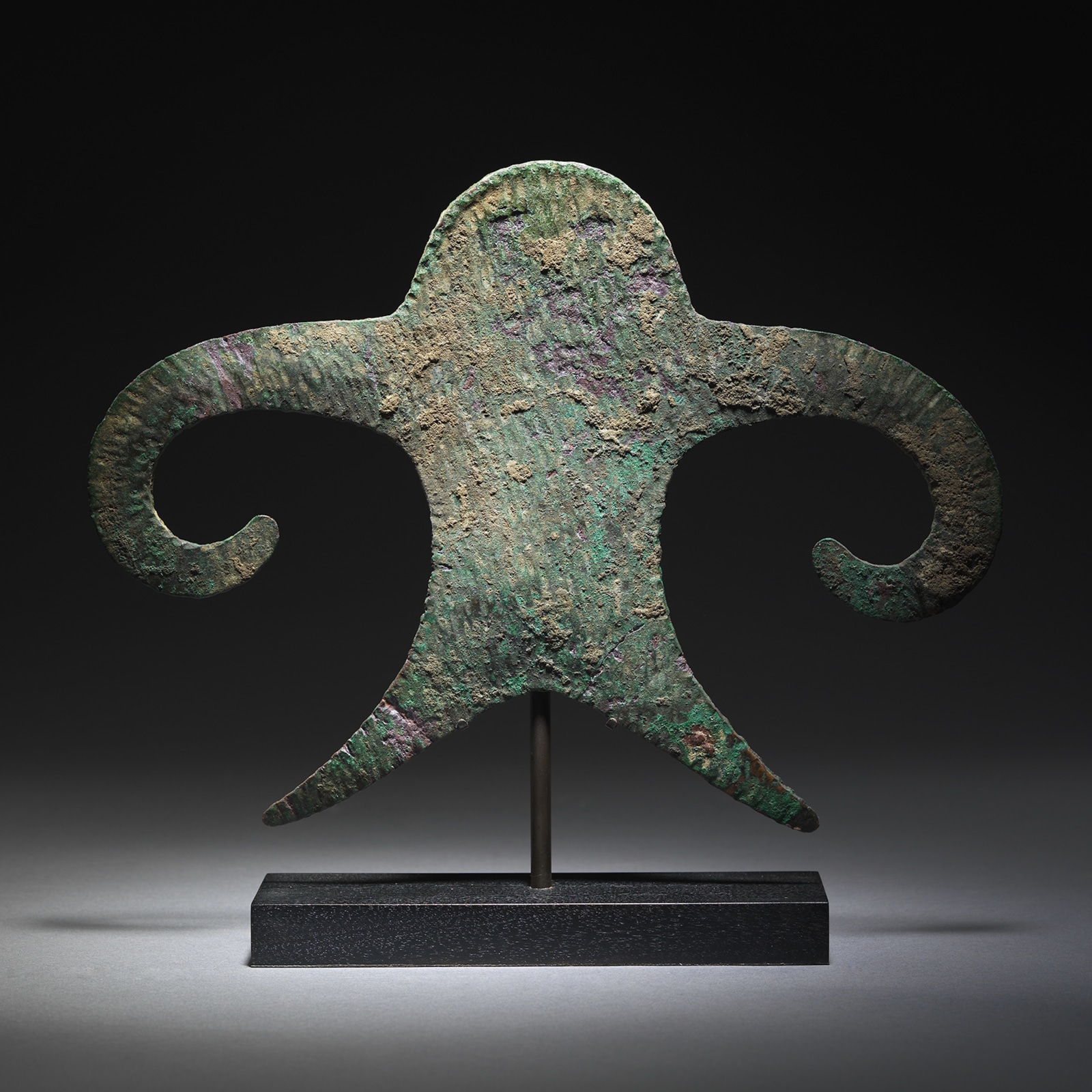 This enigmatic object is cast and hammered from a flat piece of copper into a representation of a male figure.