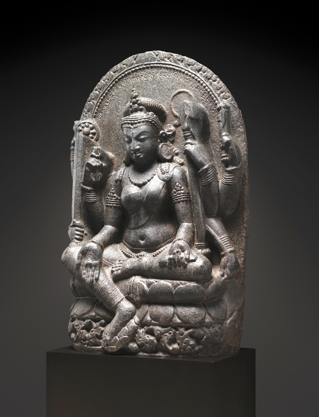 Same photo of This remarkable sculpture portrays Mahapratisara, the principal Raksha goddess, with her distinctive eight arms adorned with various symbolic attributes.