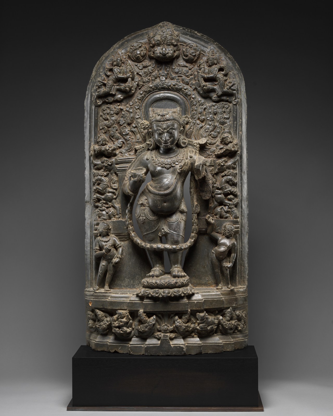 The wrathful form of Shiva is depicted standing in tribhanga on a lotus