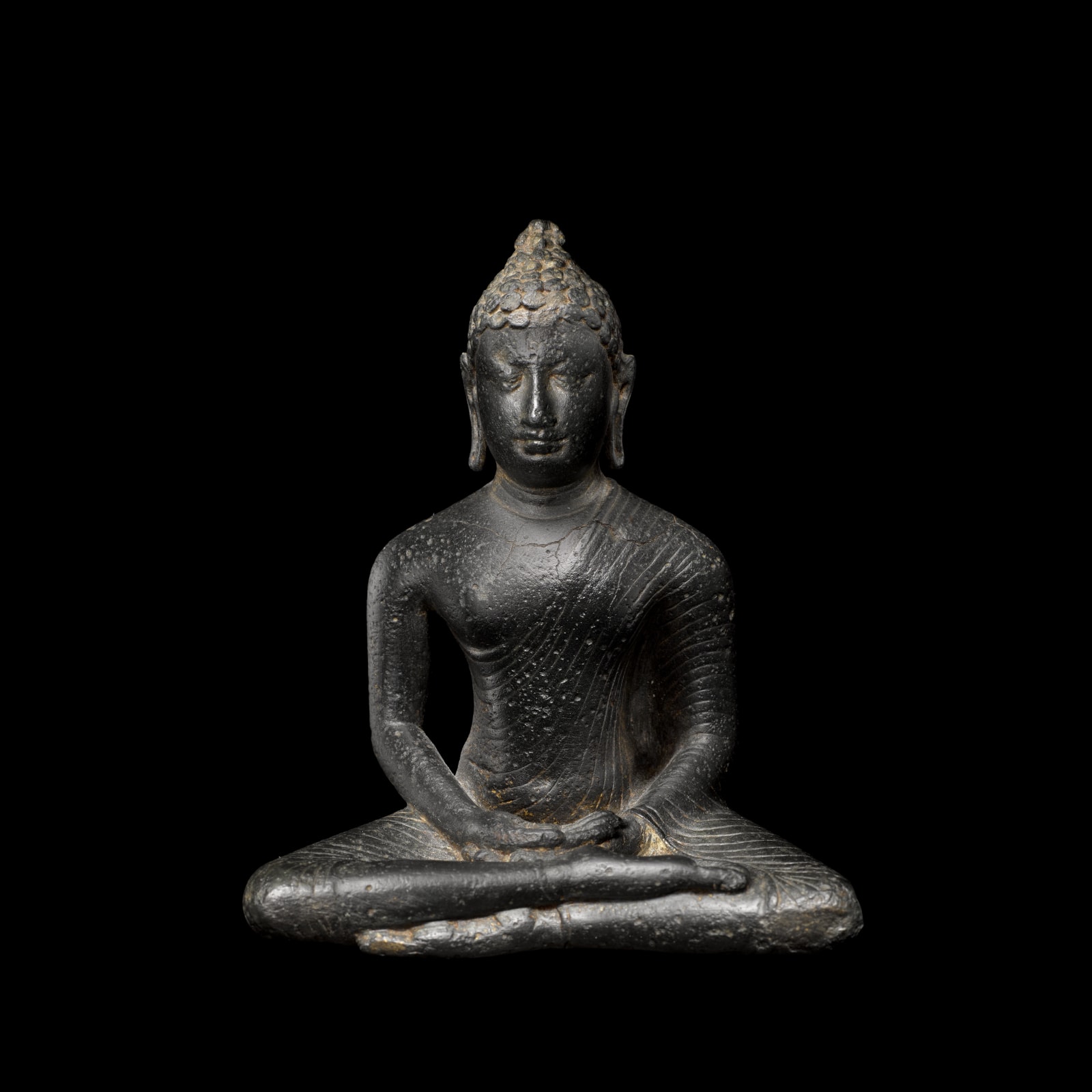 This small Buddha from the Anuradhapura period sits in the half-lotus posture (virasana), his right leg over his left