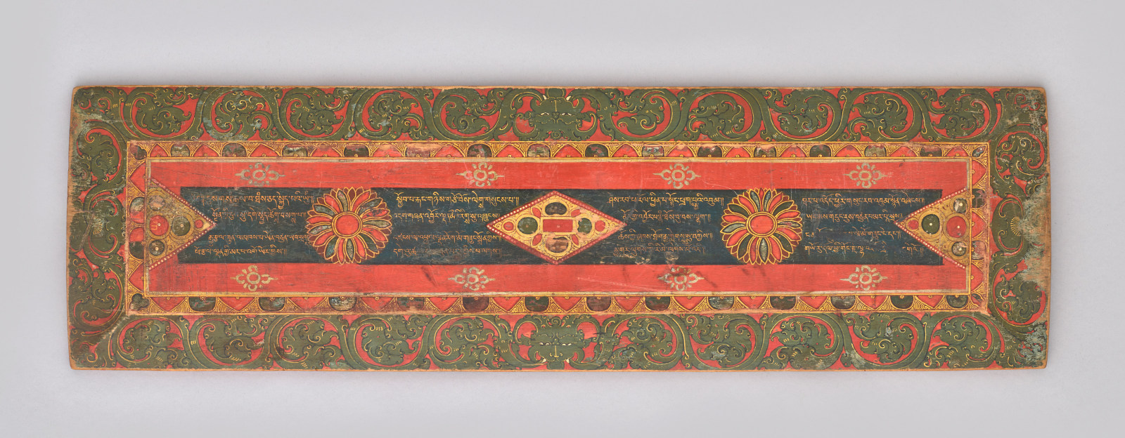 this remarkable cover is an aesthetically elegant and rare object and contains a sixteen-lined poem, beautifully executed in calligraphy by Marpa Gyor