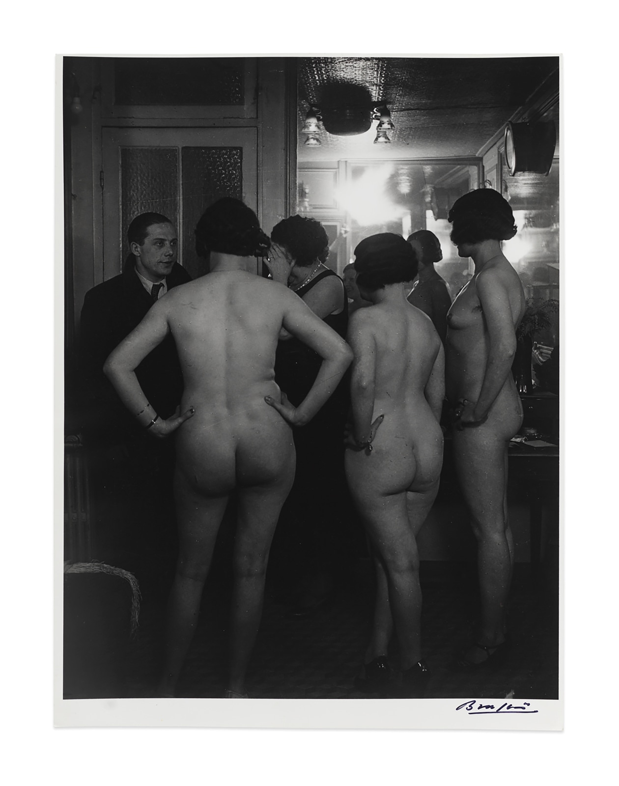 Black and white photography by Brassaï featuring the behind view of nude women standing