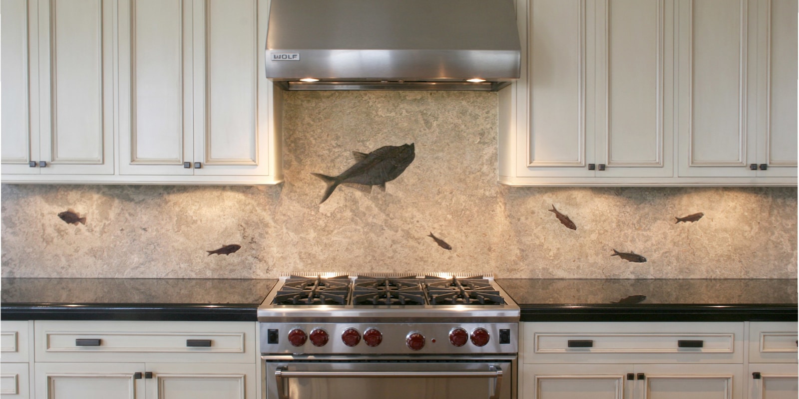 A fossil stone backsplash made from a single large slab of our &quot;Fossil Lake&quot; stone. The stone has a honed finish with the fossils in shallow relief.