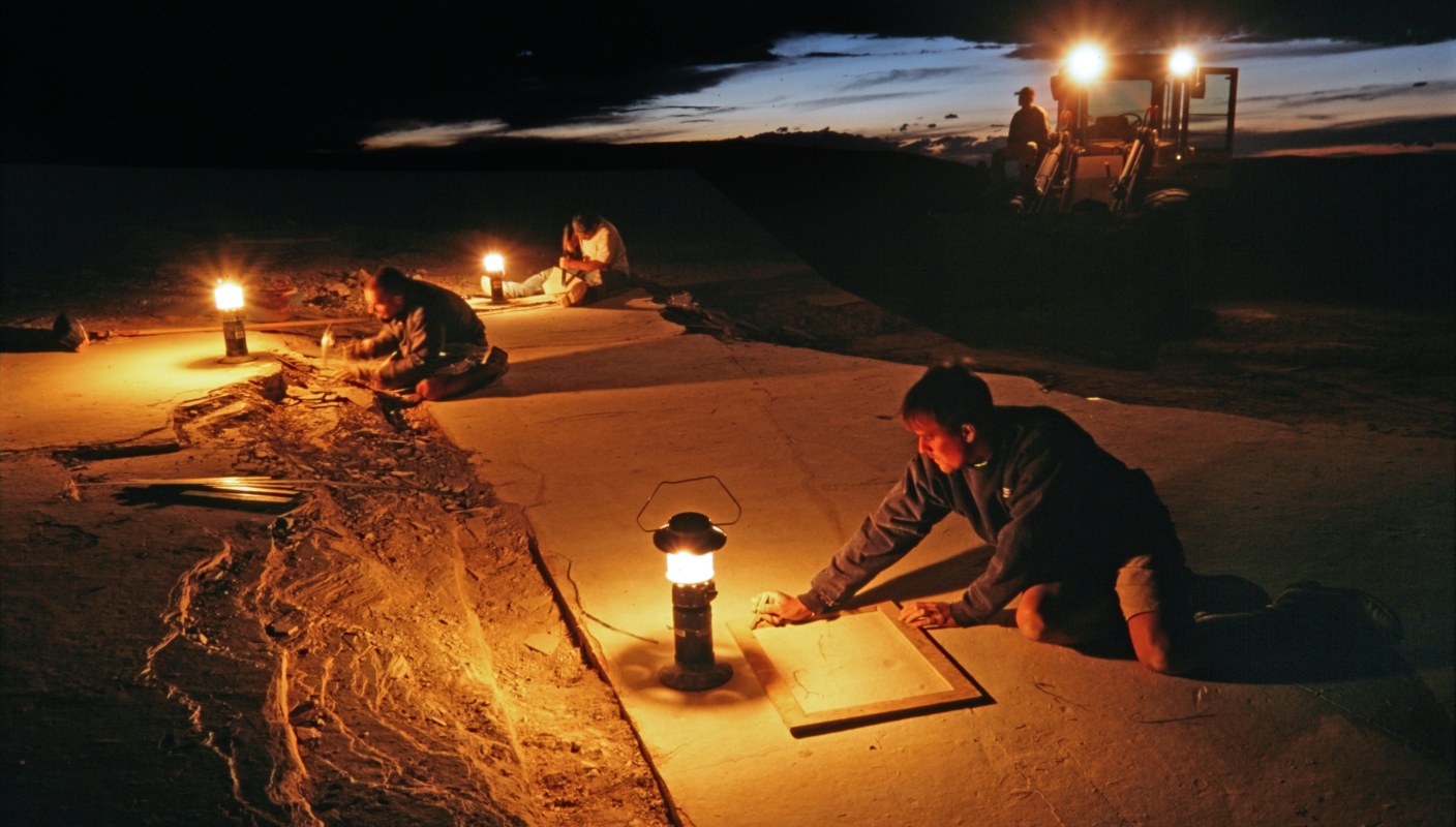 Night inspection of fossil stone is common in our quarry. Lanterns provide ideal low lighting angles when searching for fossils. Once found, the fossils are outlined in pencil. The following day our crew will return to cut and remove the fossils.