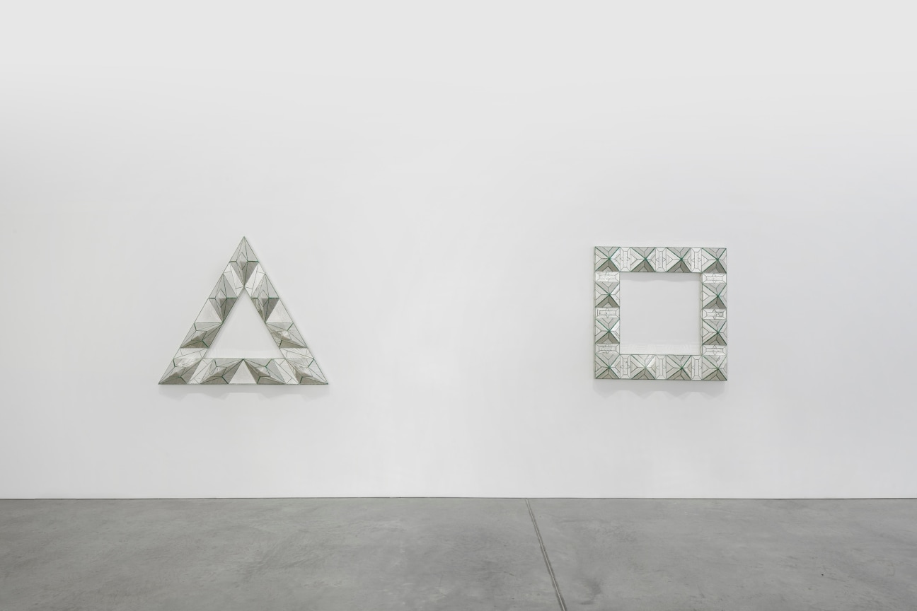 view of two geometric, glass artworks