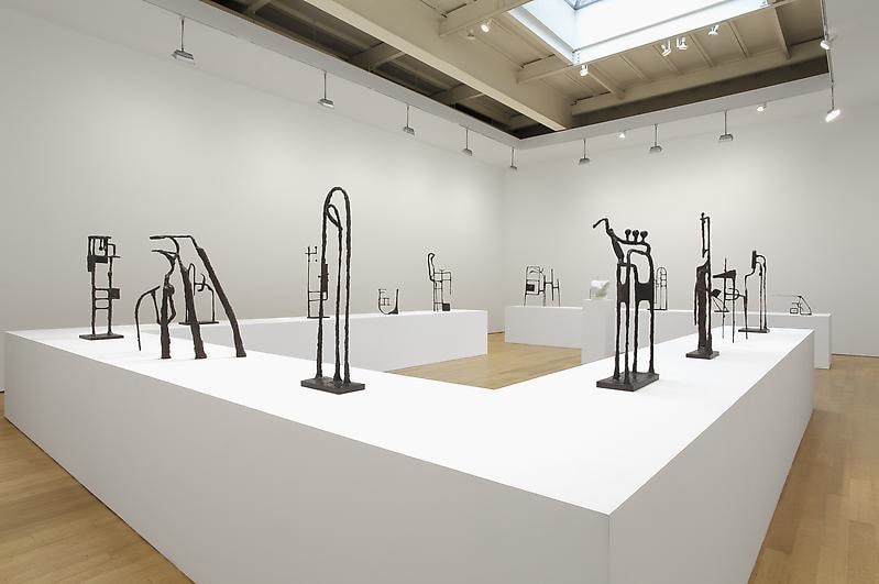 installation view of tables with abstract sculptures