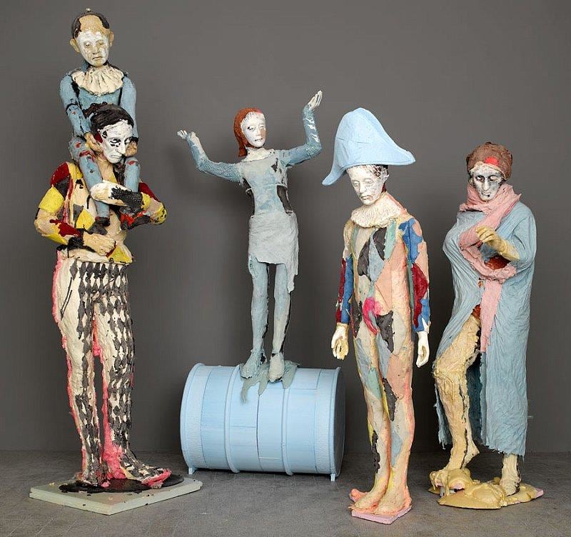 group of sad looking sculptures