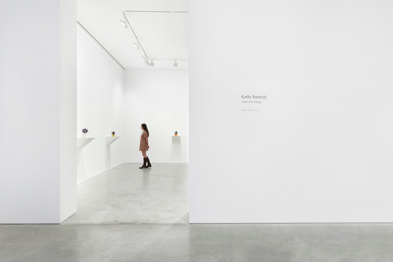 exhibition entrance revealing a person walking around the gallery