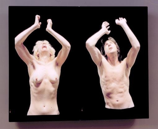 two shirtless figures with arms raised up and looking upwards