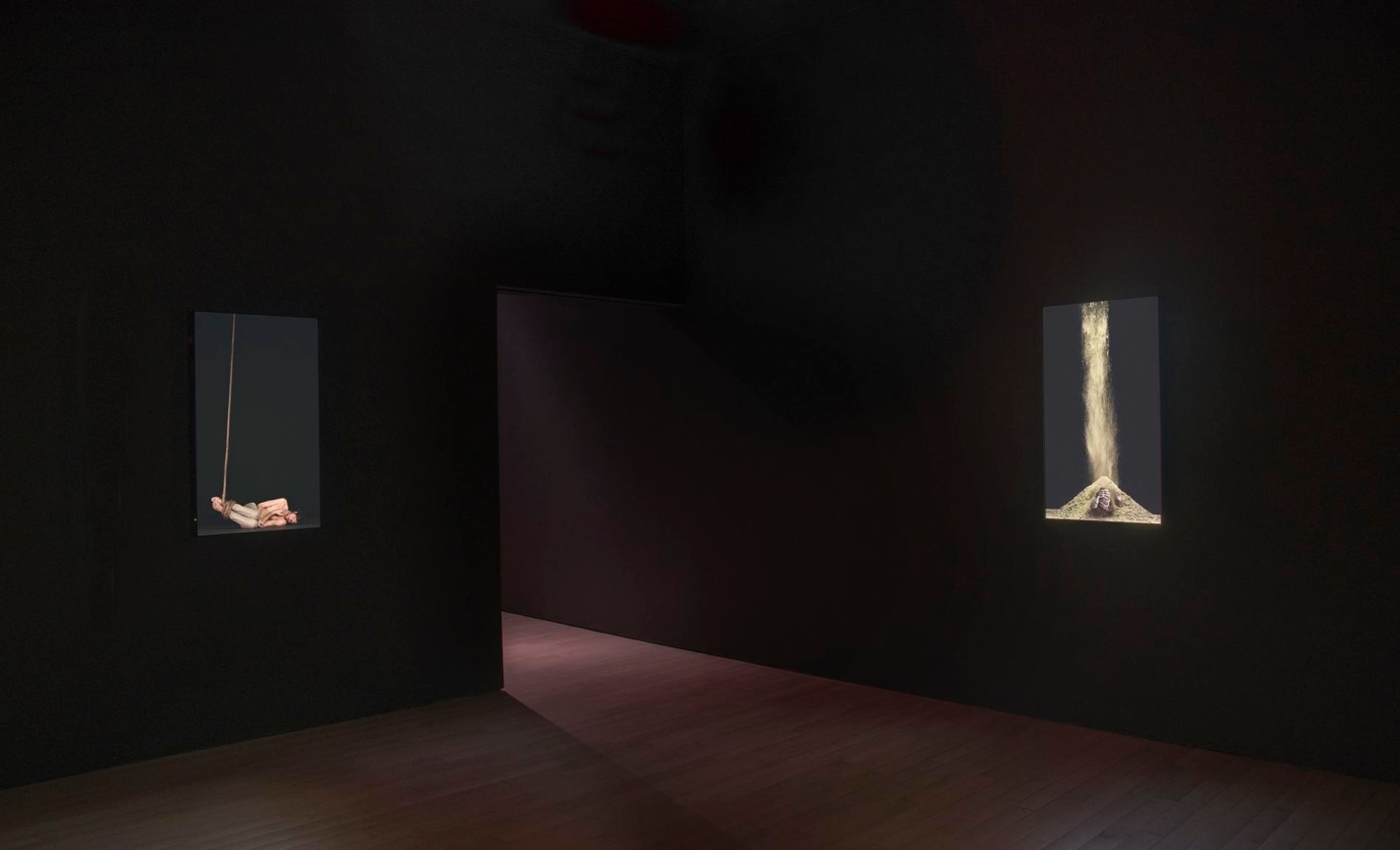 installation view of two videos in a dark room