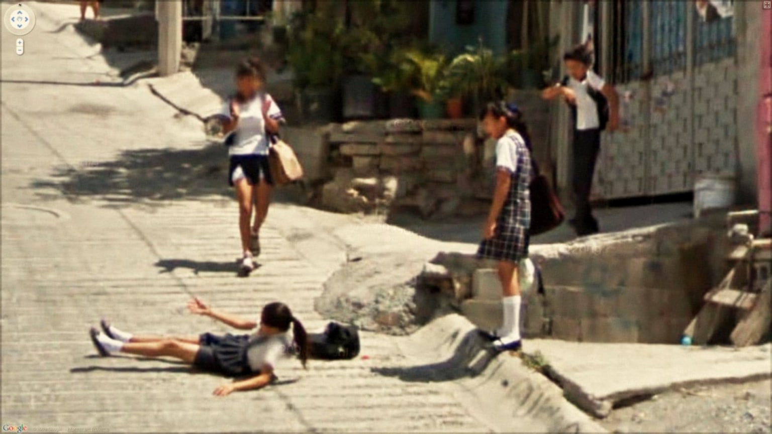 photograph of a fallen child surrounded by her peers