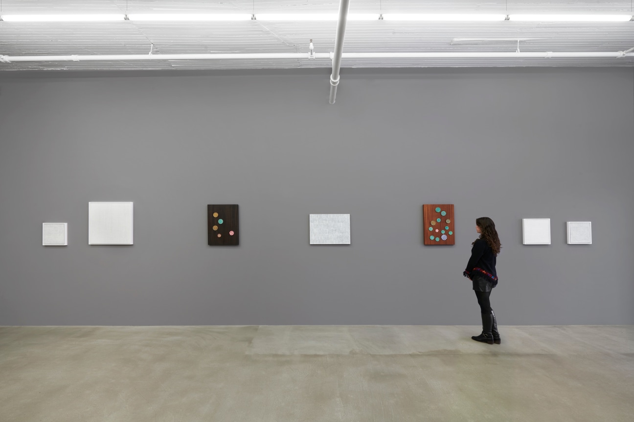 a figure contemplating the artworks