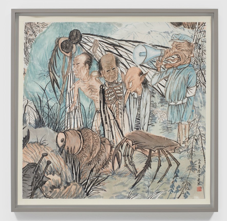 A man holding a megaphone yells at three men in rags