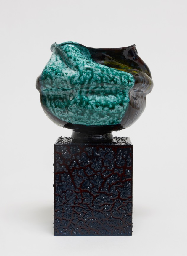 Ridged and grooved porcelain pot set on a textured cubic pedestal by Kathy Butterly.