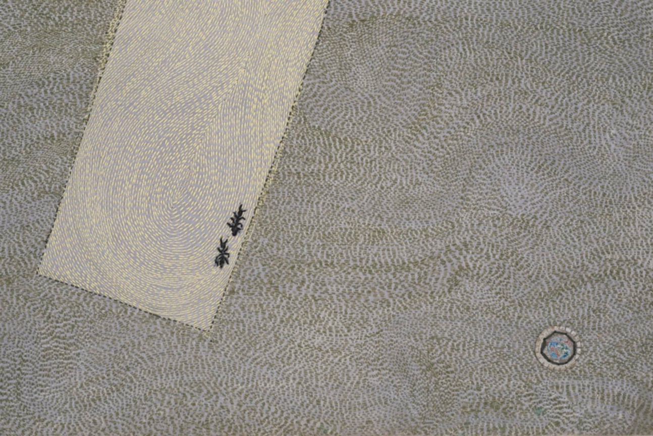 close up of white rectangle with two ants inside, and a small circle next to it