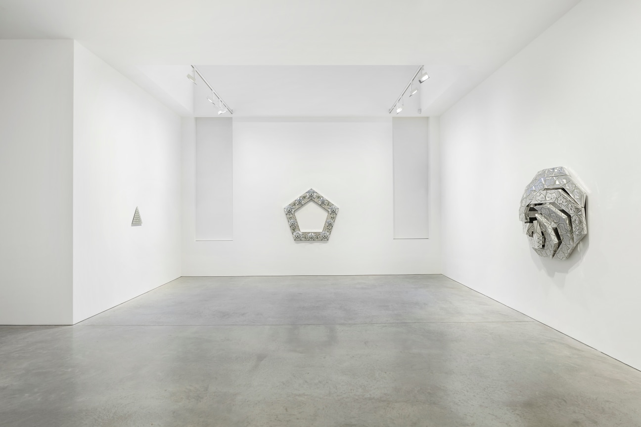 view of three glass artworks within a gallery