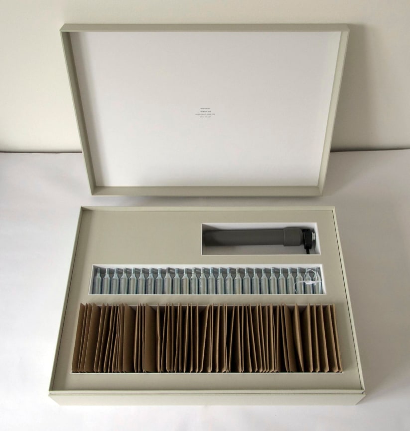 box containing confetti launcher and packets of confetti