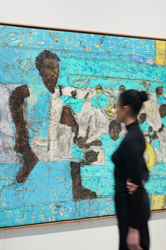 person looking at a blue artwork