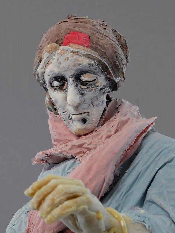 close up of statue wearing a blue robe