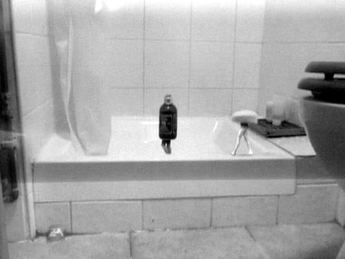 bar of soap and shampoo bottle with legs walking around a shower