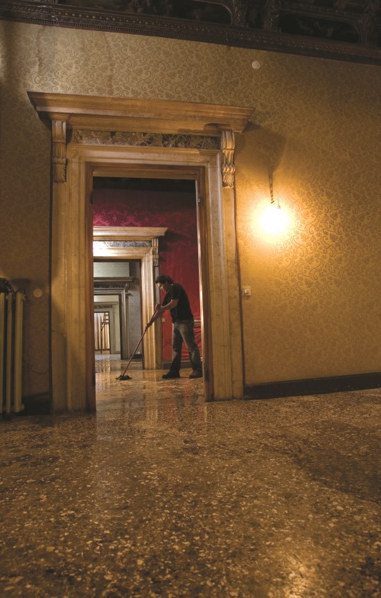open doorway revealing a man mopping the floor