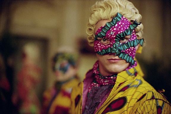 man wearing a flamboyant mask