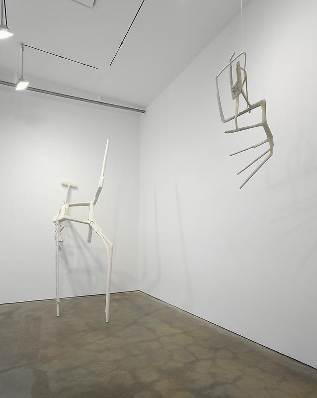 installation view of tables with abstract sculptures
