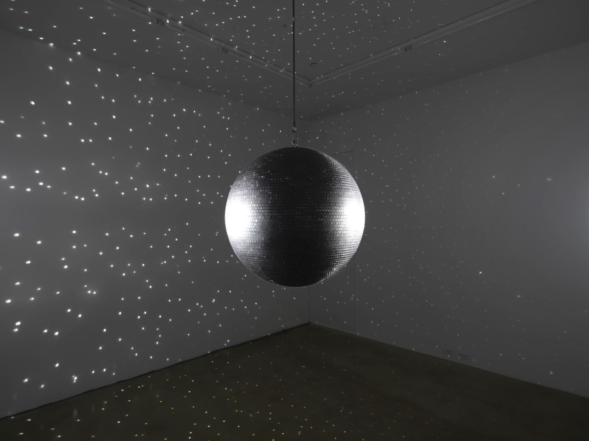 dark room lit up by a disco ball