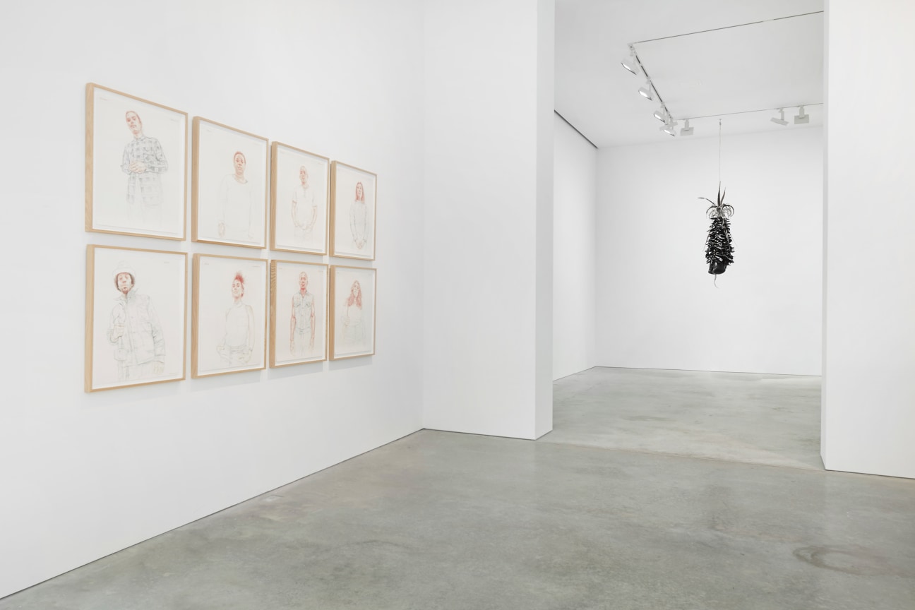 series of portrait drawings and an entryway to another room to the right