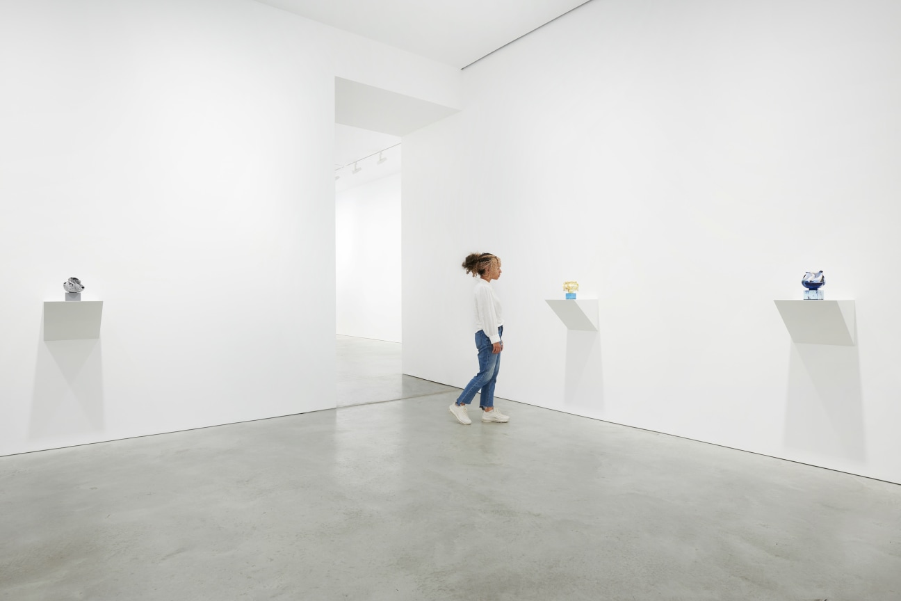 person looking at one of three small artworks