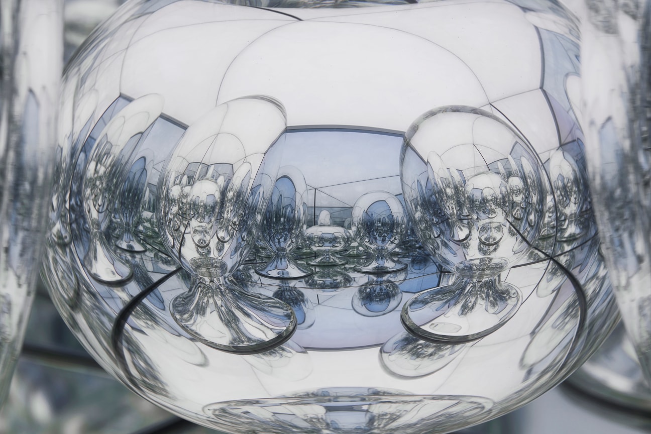 close up of glass sculpture showing the reflection of the other glass sculptures surrounding it