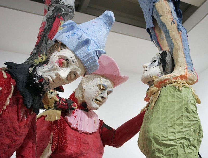 close up of statues that make up the human pyramid