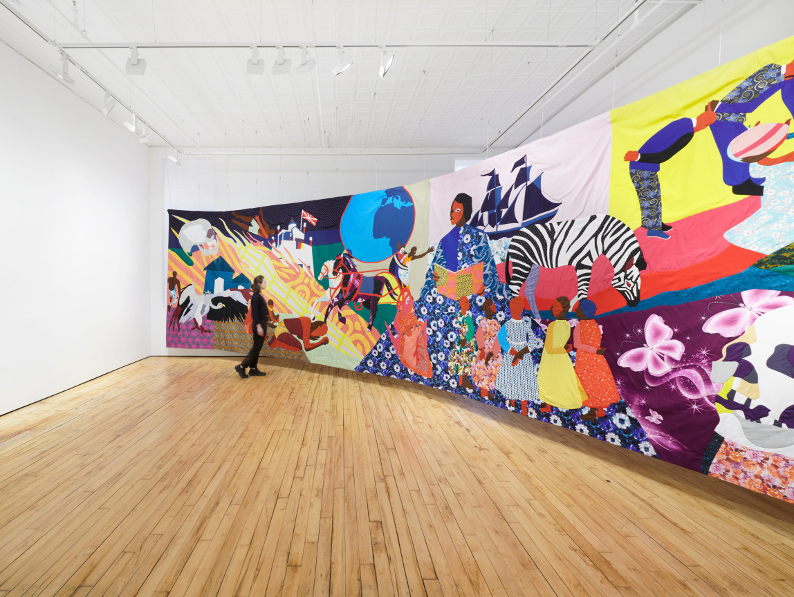 person looking at a large tapestry