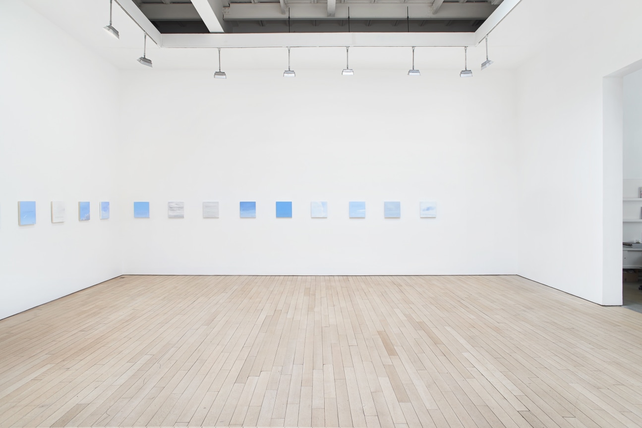 installation view of several square canvases in a row