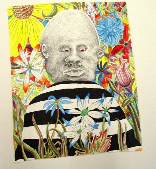 striped mound with a head on top of it surrounded by flowers