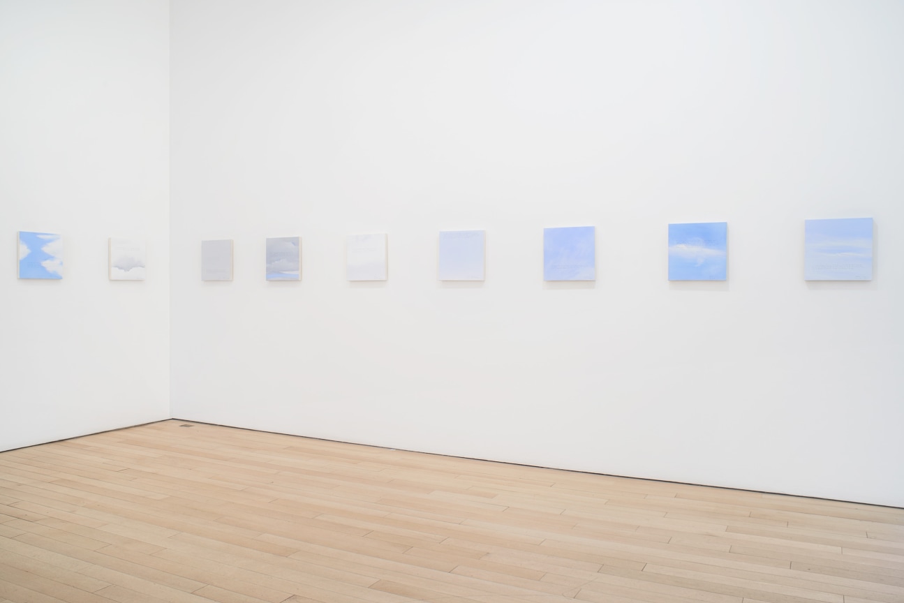 installation view of several square canvases in a row