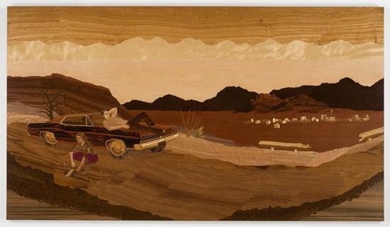 car on the side of the artwork with a view of the town in the distance