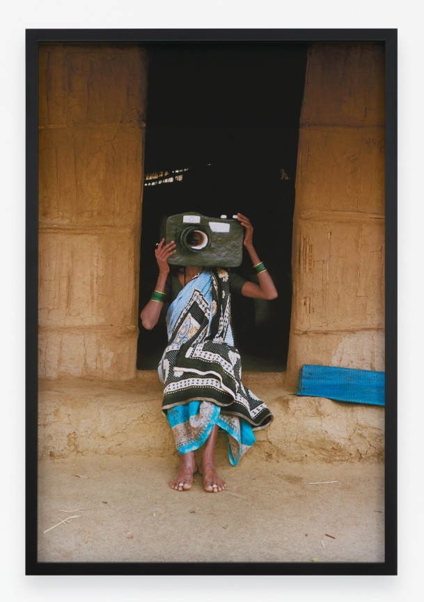 Archival pigment print featuring one person in paper Mache mask