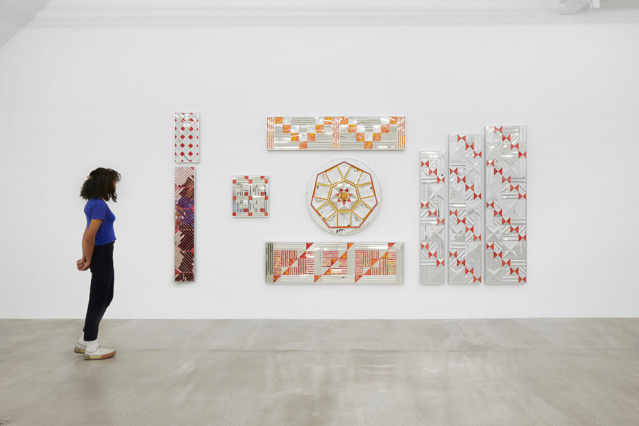 a person viewing glass artworks