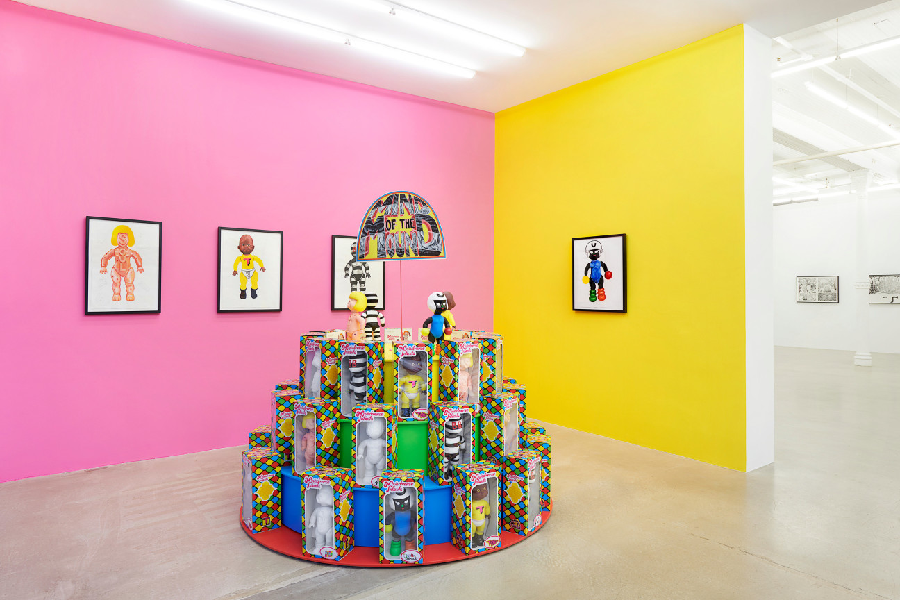 room with pink and yellow walls with a collection of action figures in the middle