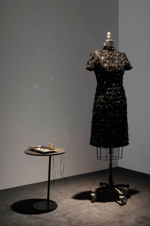 a black dress next to a small table