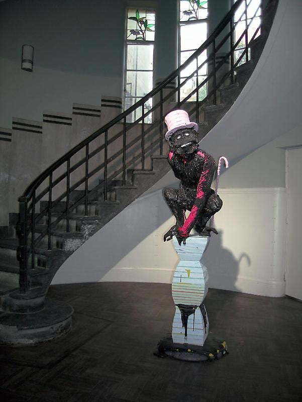 ape with a magician's hat on a pedestal