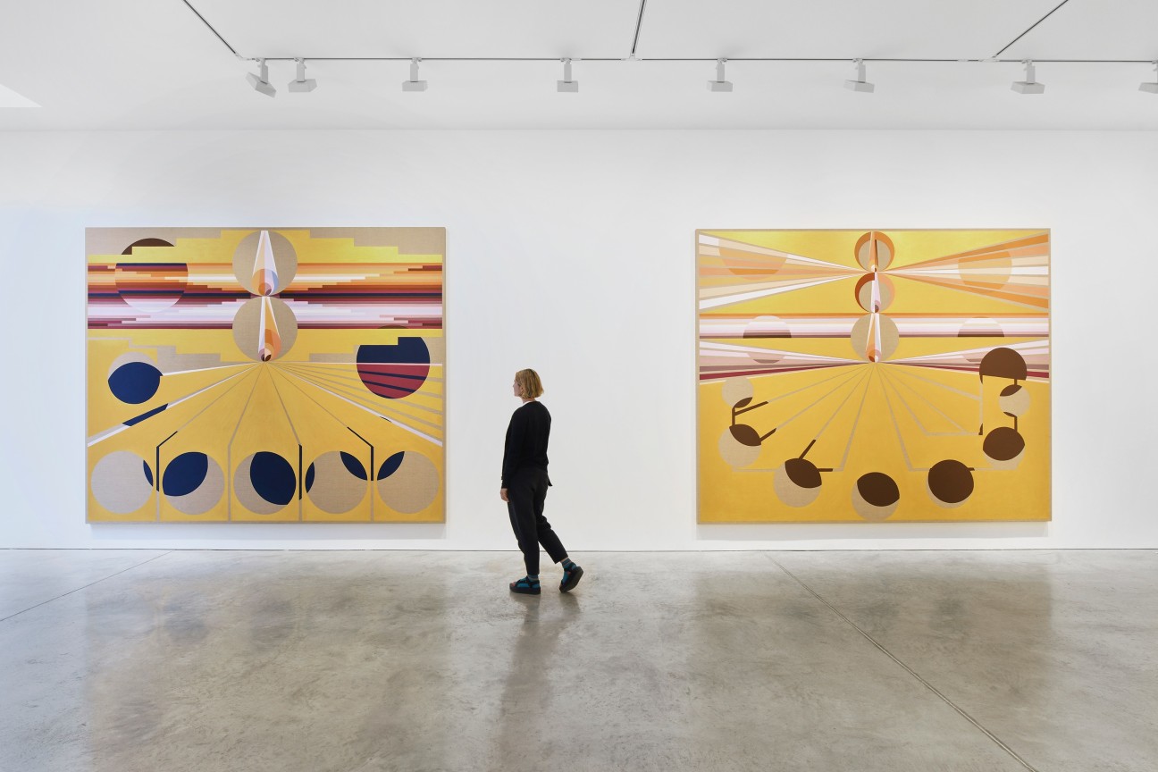 person looking at one of two paintings