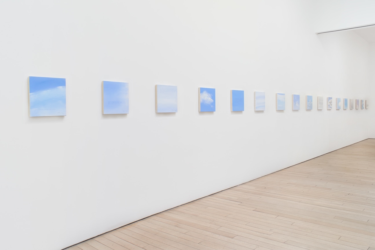 installation view of several square canvases in a row