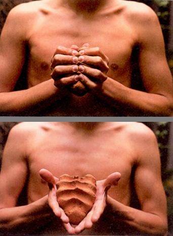 shirtless man holding moldable clay