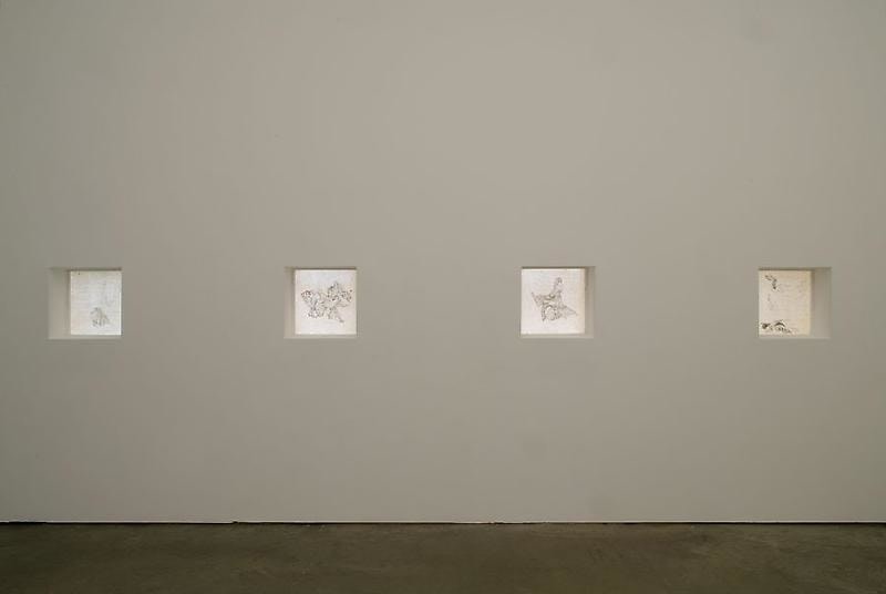 art pieces within square reliefs on the walls