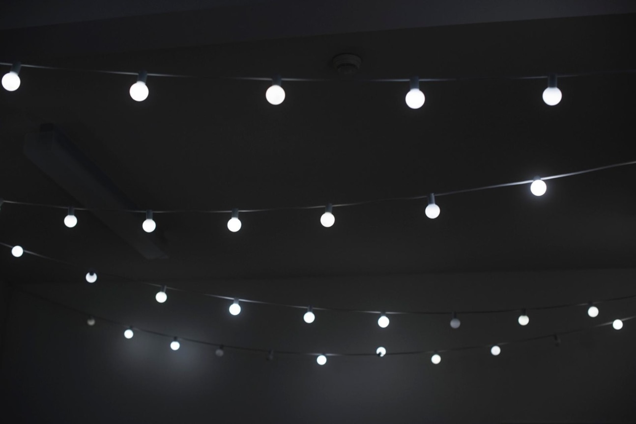 close up of a string of lightbulbs within a dark room