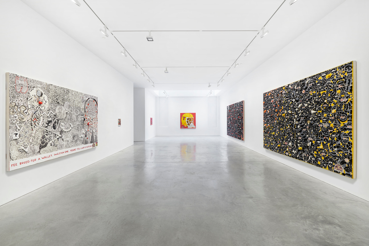 view of a long gallery with several paintings