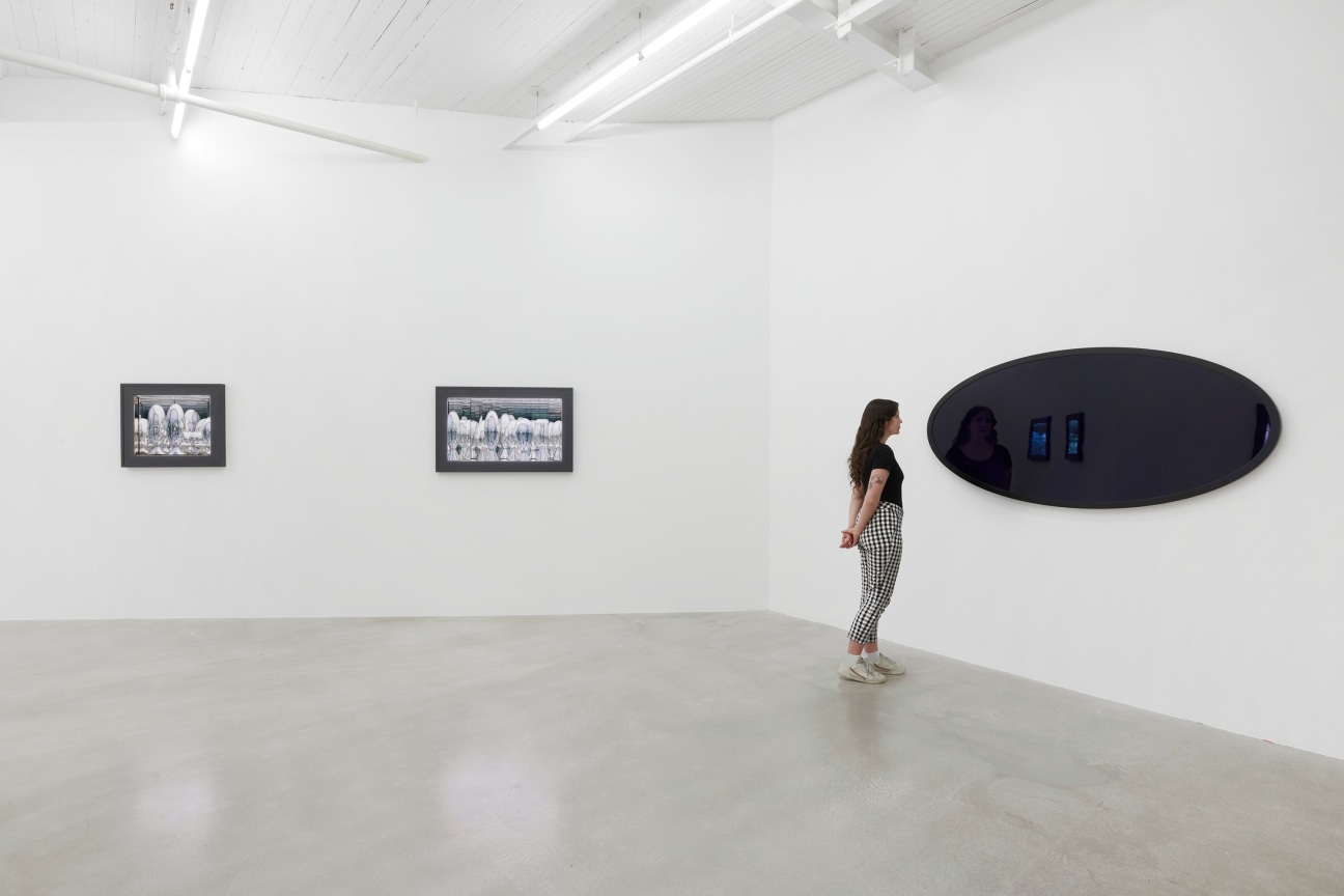 person looking at a large, black oval