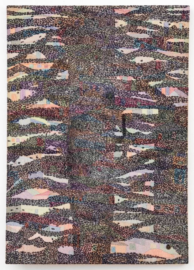 yarn stitched to look like black spots coming together in the center over a multicolored background